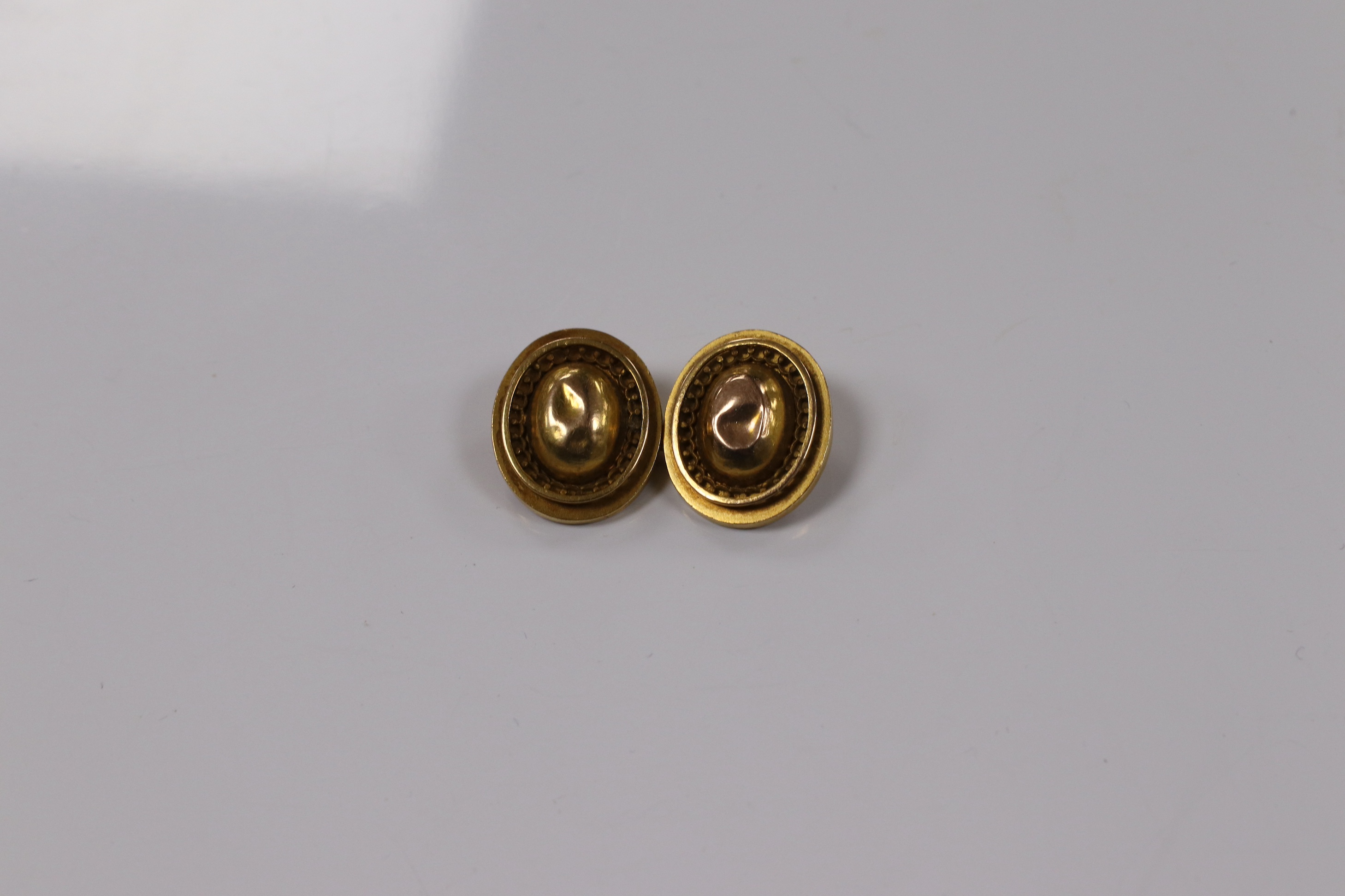 A pair of yellow metal oval cufflinks and three similar dress studs, one stamped 18, gross weight 10.8 grams. Condition - poor